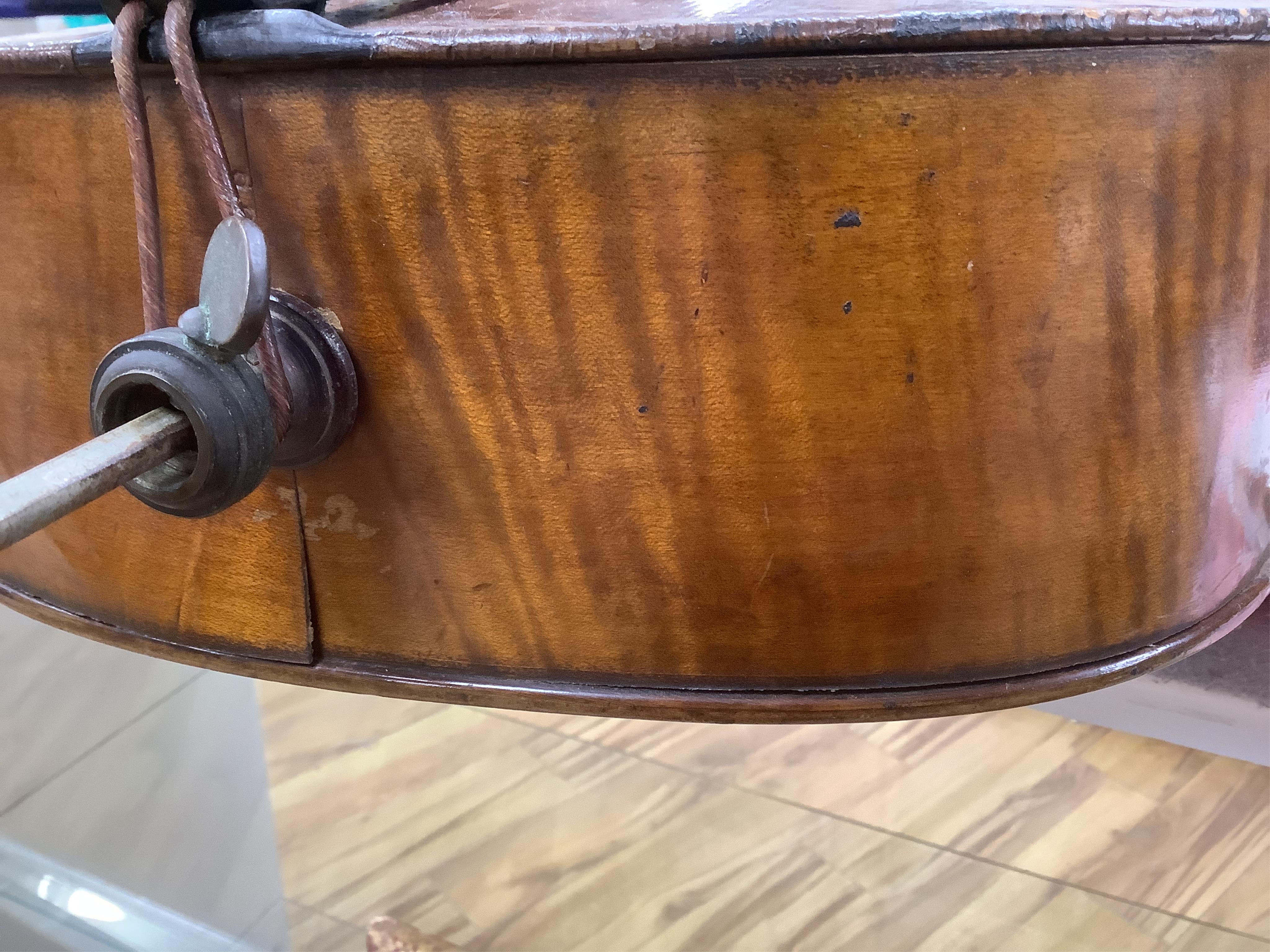 A late 19th century small cello, unsigned and without label inside body, stamped inventory number 769, length of back 62cm. Condition - poor to fair